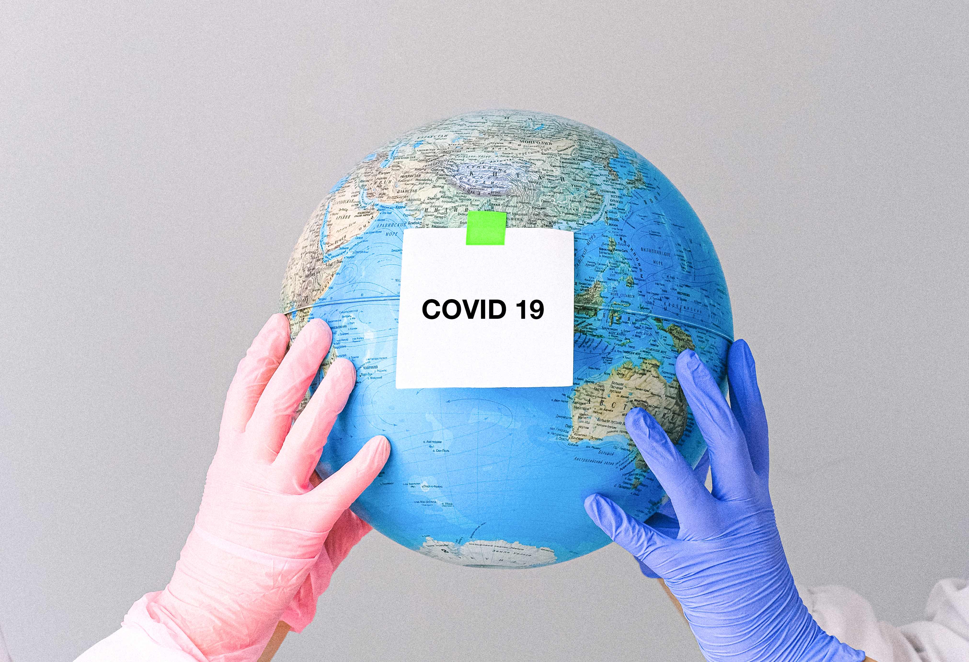 hands-with-latex-gloves-holding-a-globe-4167559.jpeg
