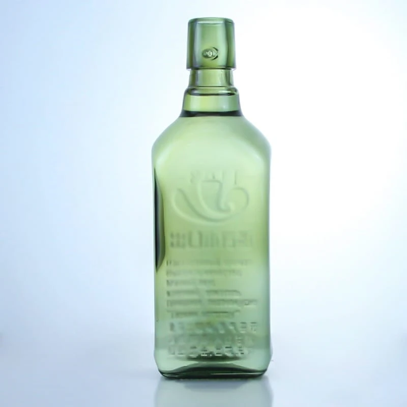 488-700ml light green embossed logo liquor bottle with swing cap